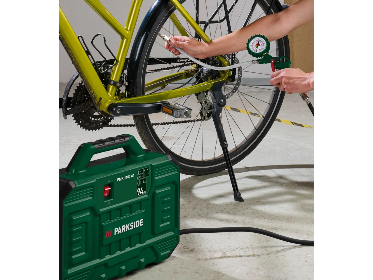 Parkside® Portable Compressor PMK 1100 A1 inflating a bicycle tire.