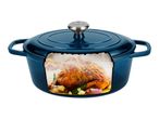 Blue cast iron pot with a roasted chicken, garlic, and herbs inside, on a white background.