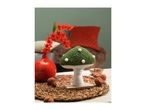 A decorative green mushroom with white spots, red flowers in a vase, and walnuts.