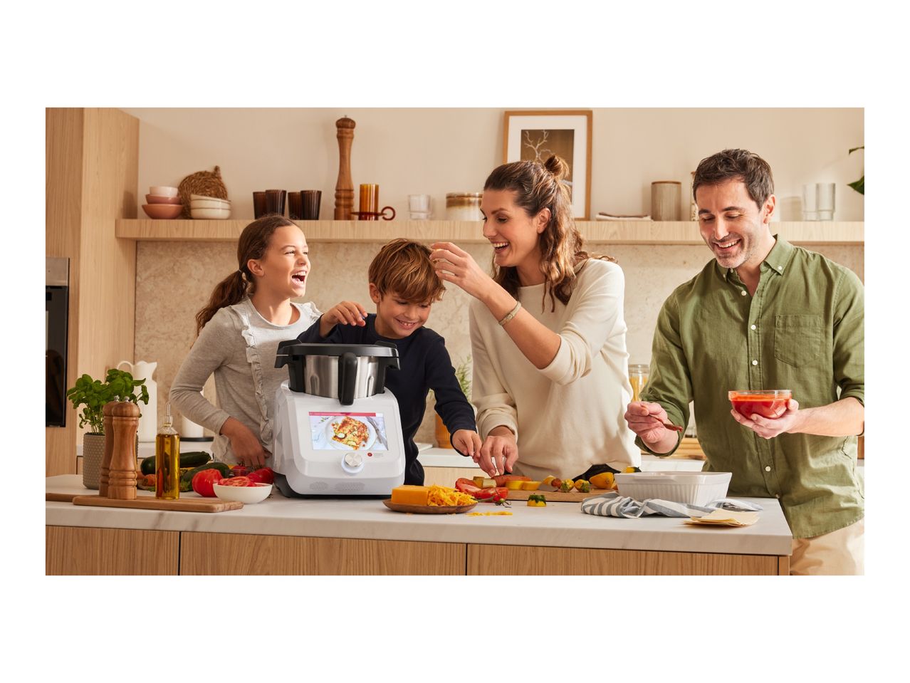Family cooking together in a modern kitchen with a Monsieur Cuisine Smart food processor.