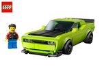 A green toy car and a minifigure with a black jacket and blue pants.