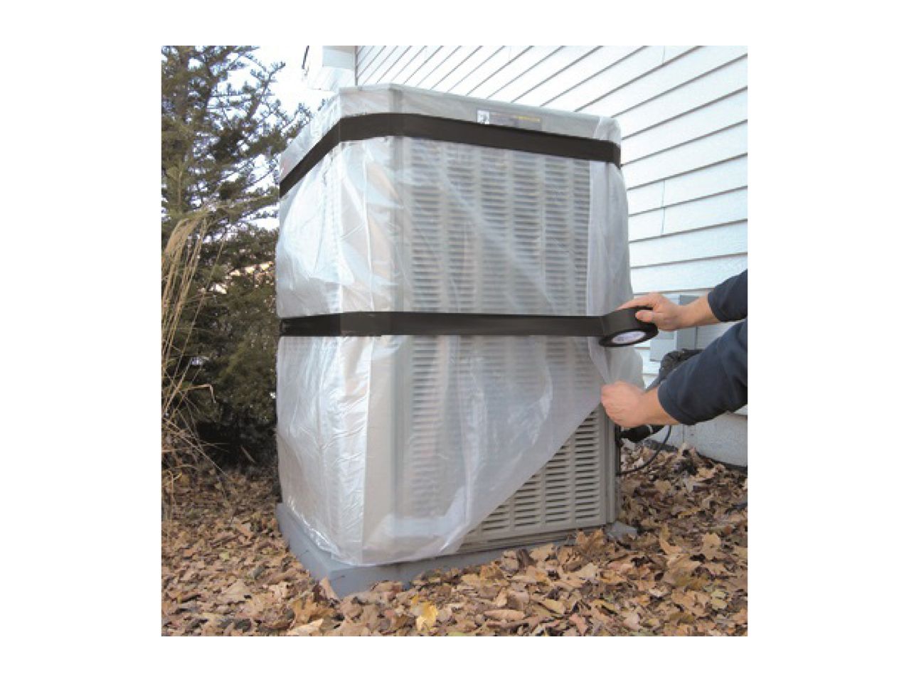 Outdoor air conditioning unit being covered with plastic sheeting and secured with black tape.