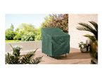 Green protective cover on a garden chair on a wooden patio with plants and trees.
