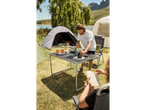 Camping: folding table, tents, and people making coffee.