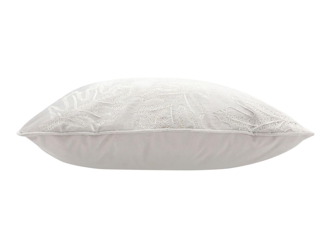White decorative cushion with embroidered leaf patterns