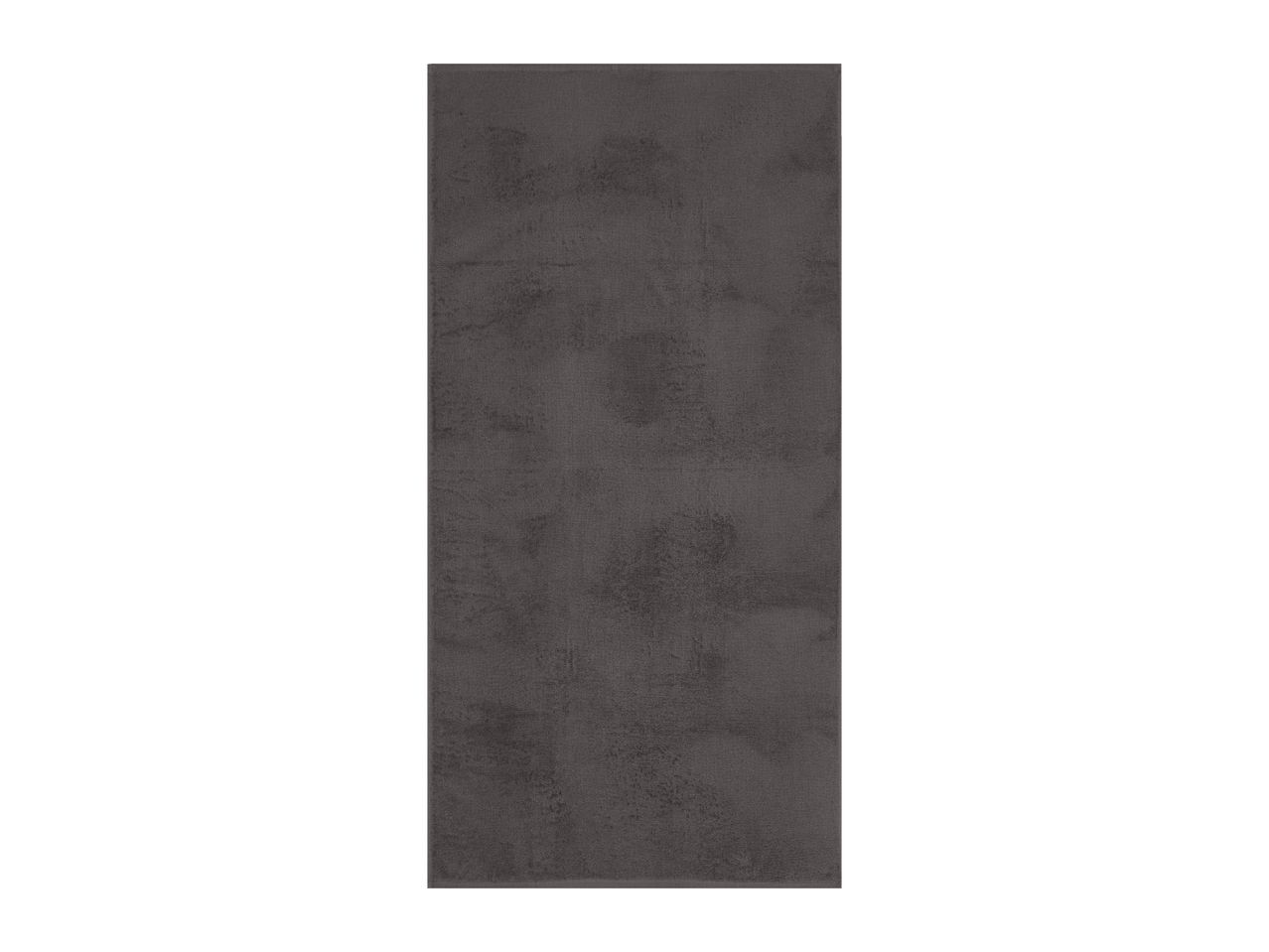 Dark grey rectangular floor tile with a textured, slightly mottled surface.
