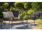 Livarno outdoor furniture set with solar bulb string lights, snacks, and drinks on a patio.