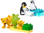 Toy penguin and lion figures made from bricks, with green and water elements.