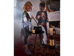 Two children in Halloween costumes stir a cauldron, surrounded by spooky decorations.