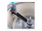 Close-up of a cleaning brush inside a washing machine drum.