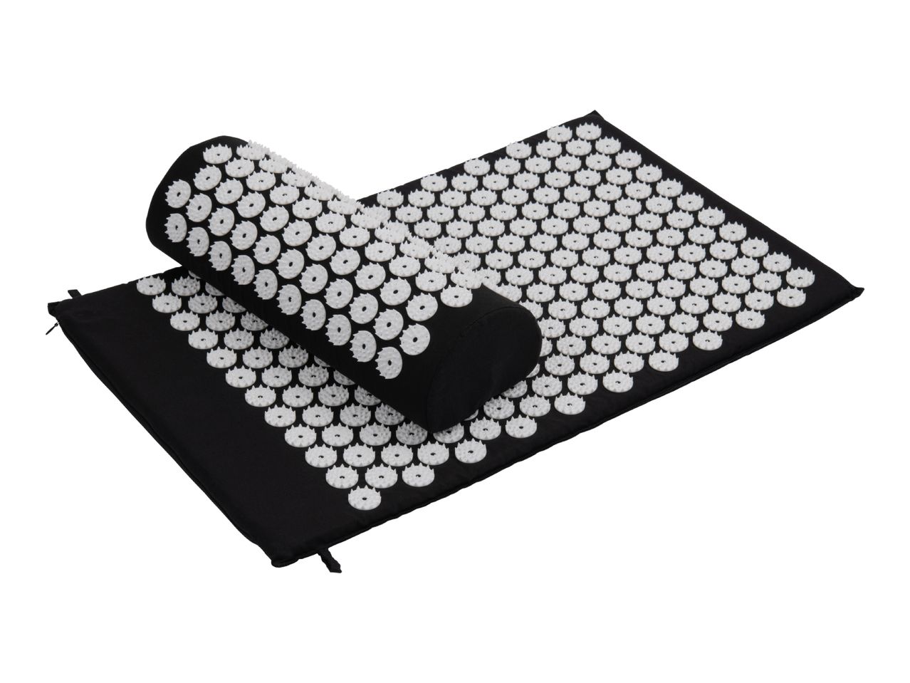 Black acupressure mat and pillow with white plastic spikes