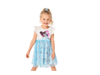 Smiling girl in a white and blue dress with Coco & Bluey characters and a sequin heart.