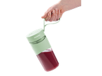 Mână ținând un blender portabil Silvercrest® pentru smoothie cu băutură roșie.