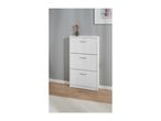 White shoe cabinet with three drawers, a vase with dried flowers, and a framed picture.
