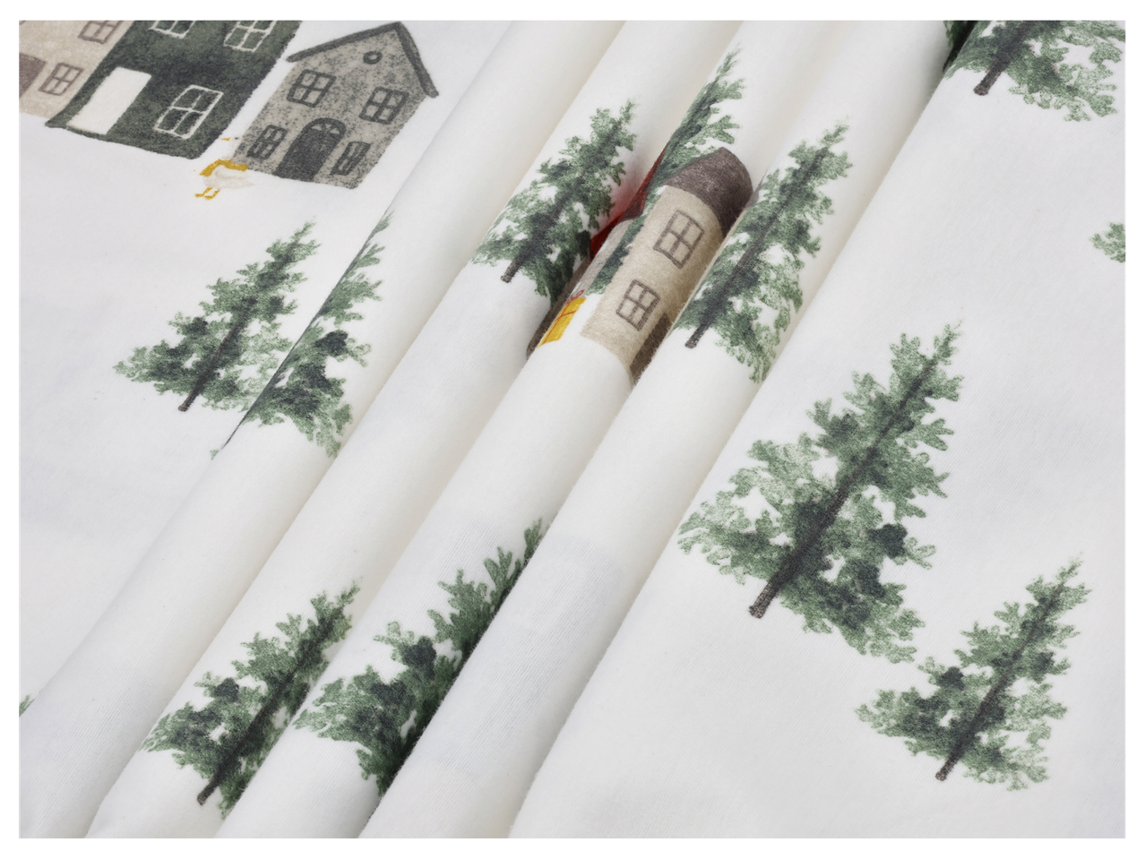 Valge kangas roheliste kuuskede ja majade mustriga talvisel maastikul.