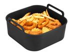 Black silicone air fryer liner filled with crinkle-cut fries and onion rings