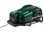 Green robotic lawnmower on its charging station, with control panel and large wheels.
