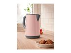 Pink electric kettle on a wooden kitchen counter with cookies and tea.