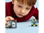 Boy playing with building blocks: an ATM with a „WANTED!” poster and a figure on a skateboard.