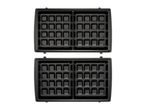 Open waffle maker with two sets of square waffle plates.