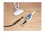Steam mop and handheld steam cleaner with various attachments on a wooden floor.