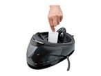 Inserting an anti-limescale filter cartridge into a steam generator iron base