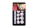 Siao Long Pao dumplings med rejer i en sort bakke med spisepinde og en dekorativ etiket.