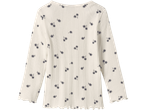Gräddvit långärmad topp med ribbad textur och mörkblått blommönster.