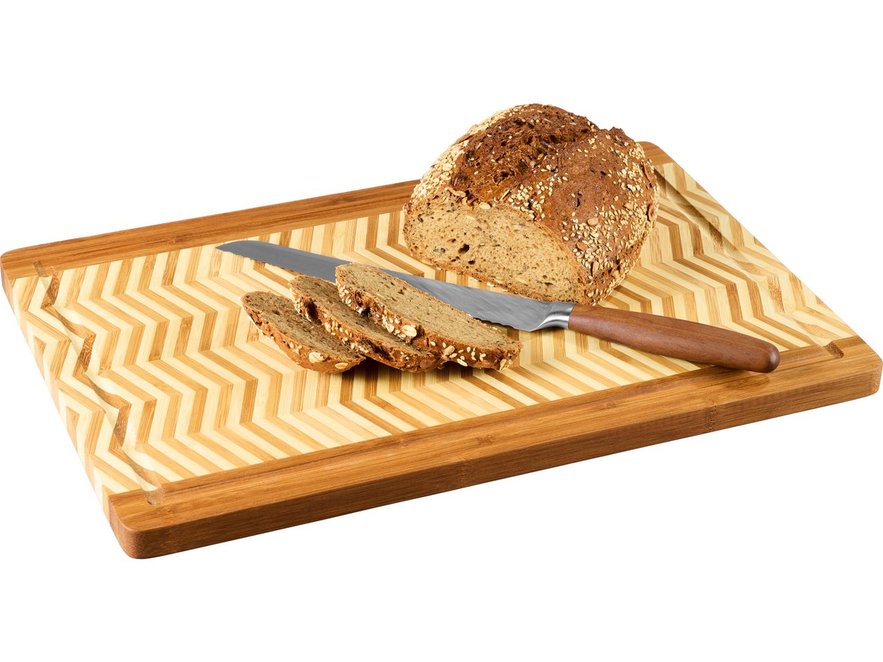 A loaf of multigrain bread, sliced, with a knife on a bamboo cutting board.
