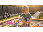 Lupilu sand toys: a child playing in a sandbox with a bucket, shovel, and ice cream cone molds.