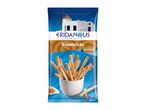 Greek style breadsticks with sesame in a white cup, against a blue background with a windmill.
