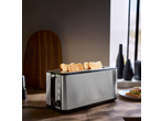 Stainless steel toaster with four slices of golden toast on a wooden kitchen counter.