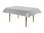 A rectangular table with light wooden legs covered by a plain white tablecloth.