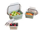 Three collapsible food containers with fresh salad, bell peppers, and berries.