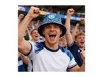 Excited man in a bucket hat and t-shirt cheering at a sports event.
