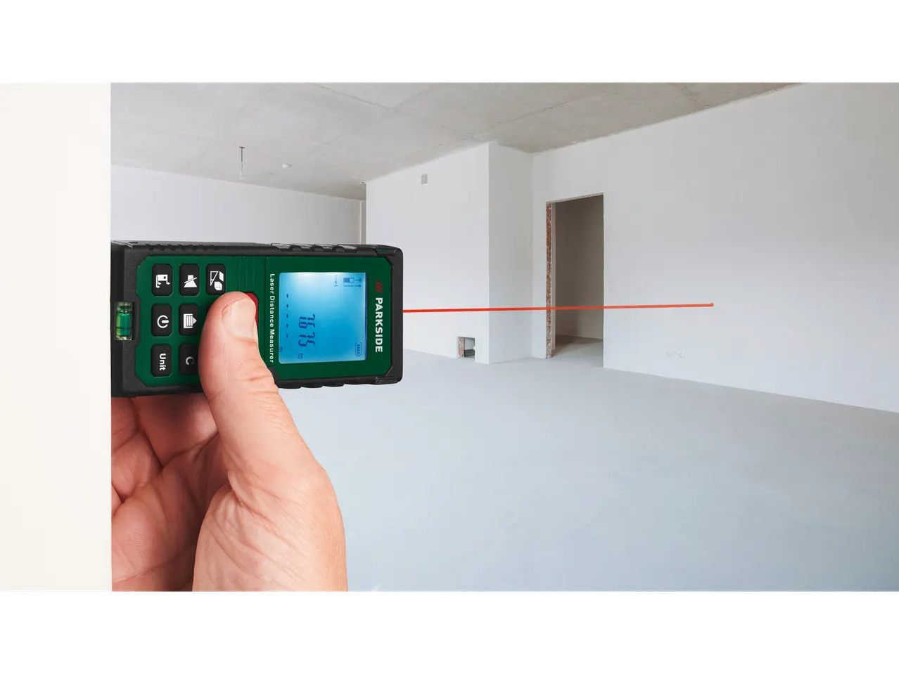 Parkside laser distance measurer in use, measuring an empty room.