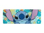 Stitch desk mat with a tropical floral and leaf pattern background.
