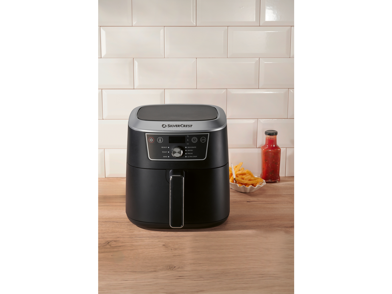 SILVERCREST® 2150W Air Fryer on a wooden counter with fries and sauce