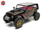 Black toy off-road vehicle with flame decals and exposed engine on a white background.