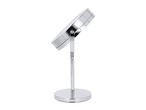 Chrome-plated cosmetic mirror with a round base and adjustable angle, viewed from the side.