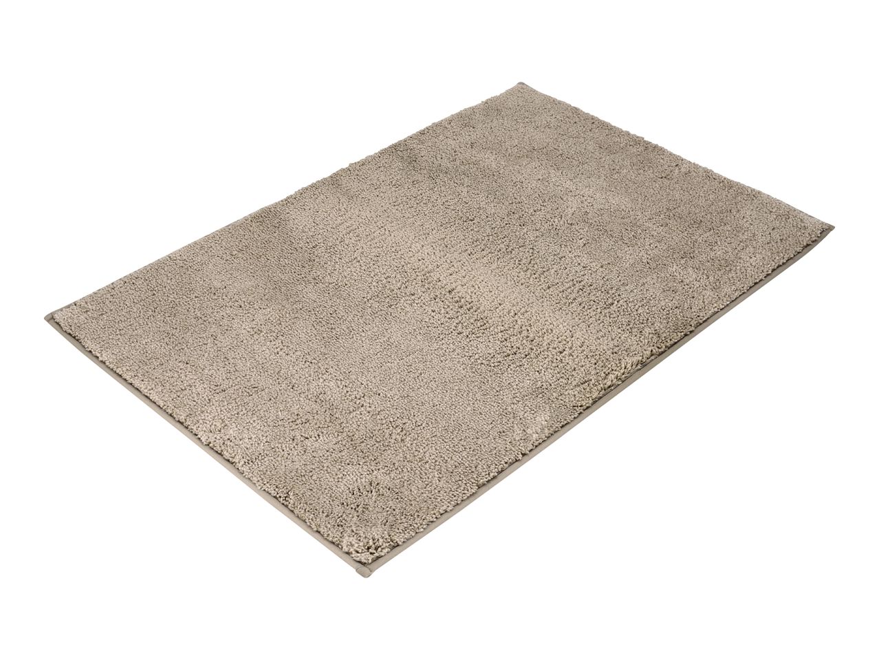 Rectangular beige bath mat with a textured surface