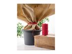 Red garden twine next to a potted plant wrapped in protective winter fleece.