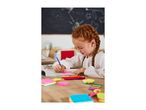 Girl writing on a pink sticky note with a blue pen, surrounded by colorful stationery.