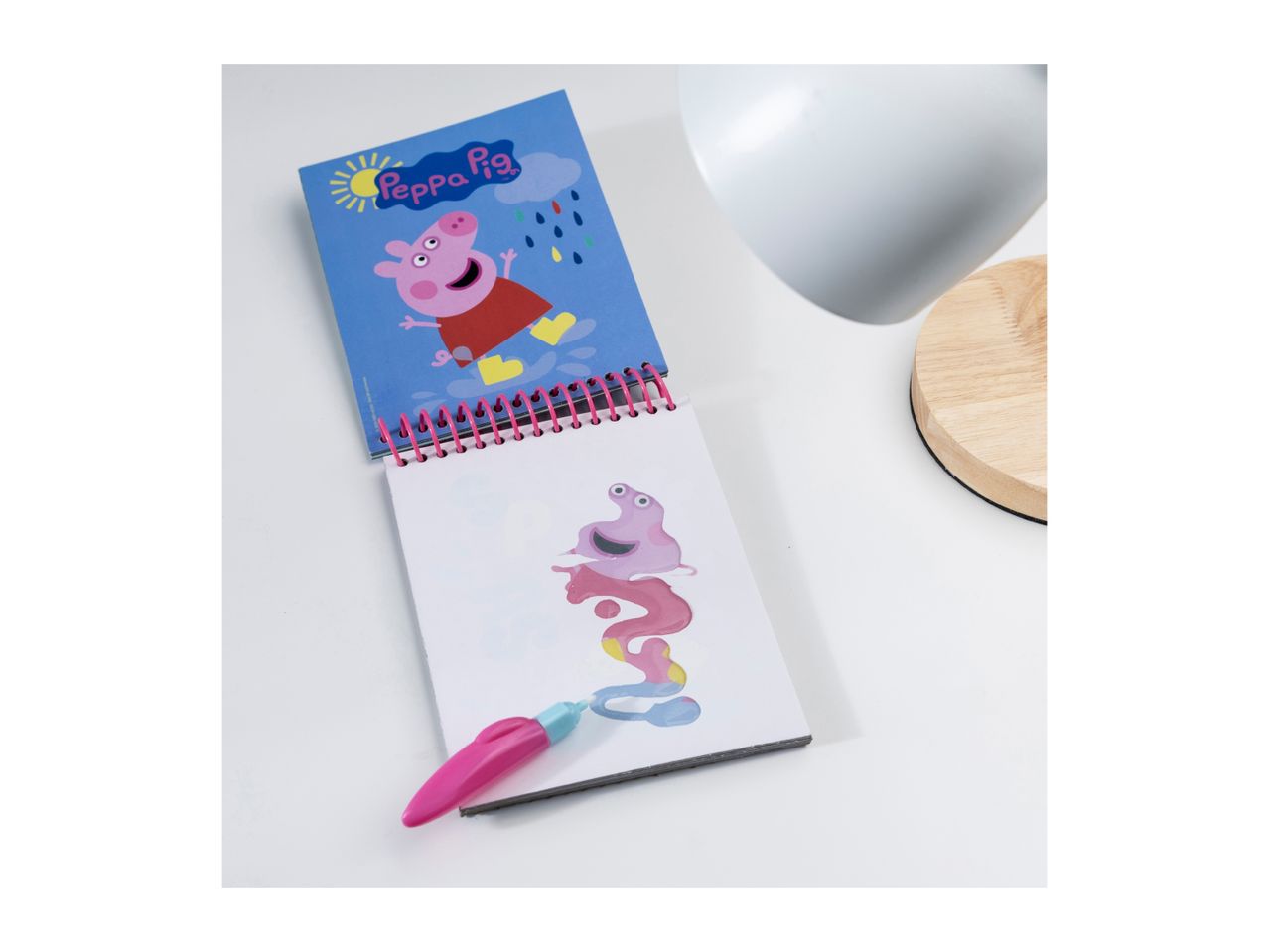 Peppa Pig spiral notebook with a water pen and colorful drawing.
