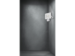 A motion sensor LED floodlight in a dark corner.