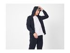 Man in a navy blue zip-up hoodie, white t-shirt, and navy blue joggers.