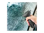 Hand holding a black emergency hammer against a shattered car window.