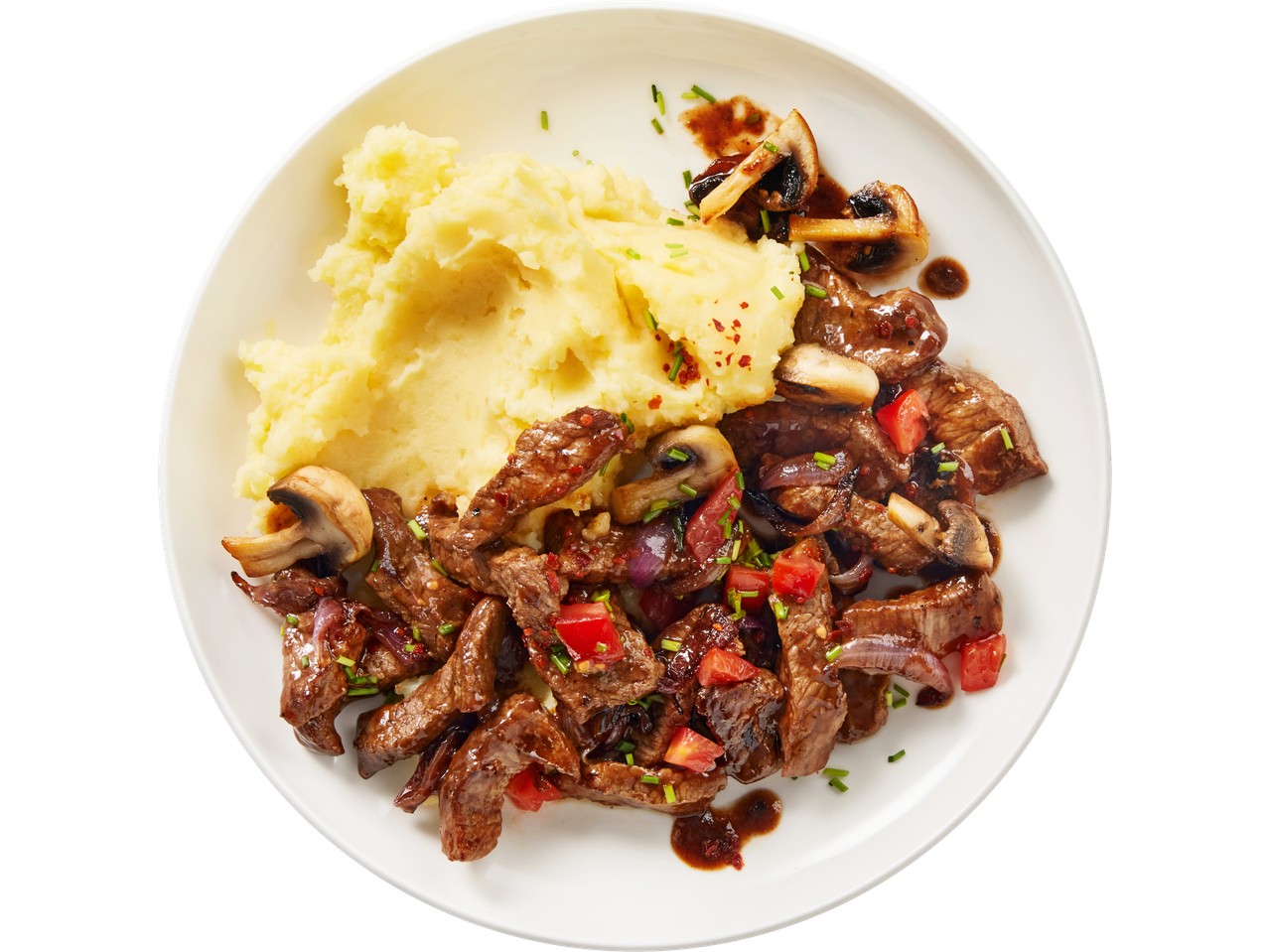 Irish Beef Stir Fry with mashed potatoes, mushrooms, red onions, and tomatoes.