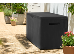 Black rattan-style outdoor storage box on a patio with potted plants.