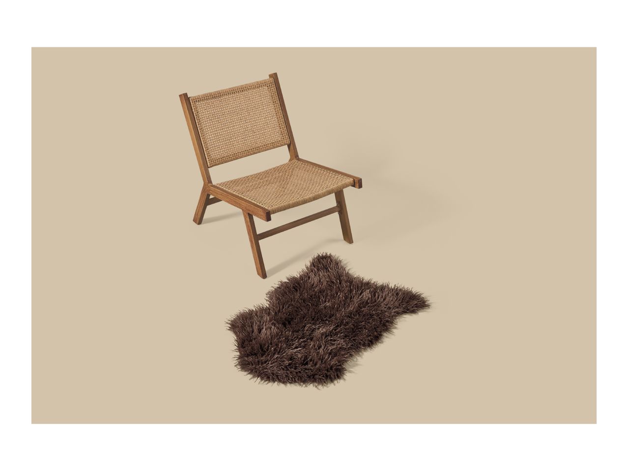 A wooden lounge chair with woven seat and backrest next to a brown faux fur rug.